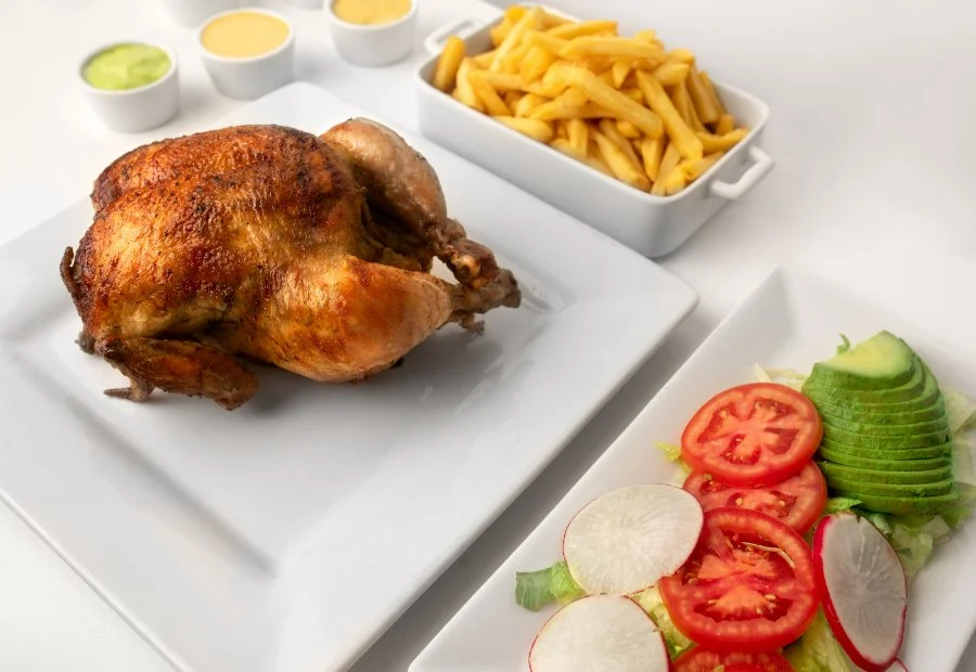 Golden whole rotisserie chicken fresh off the spit